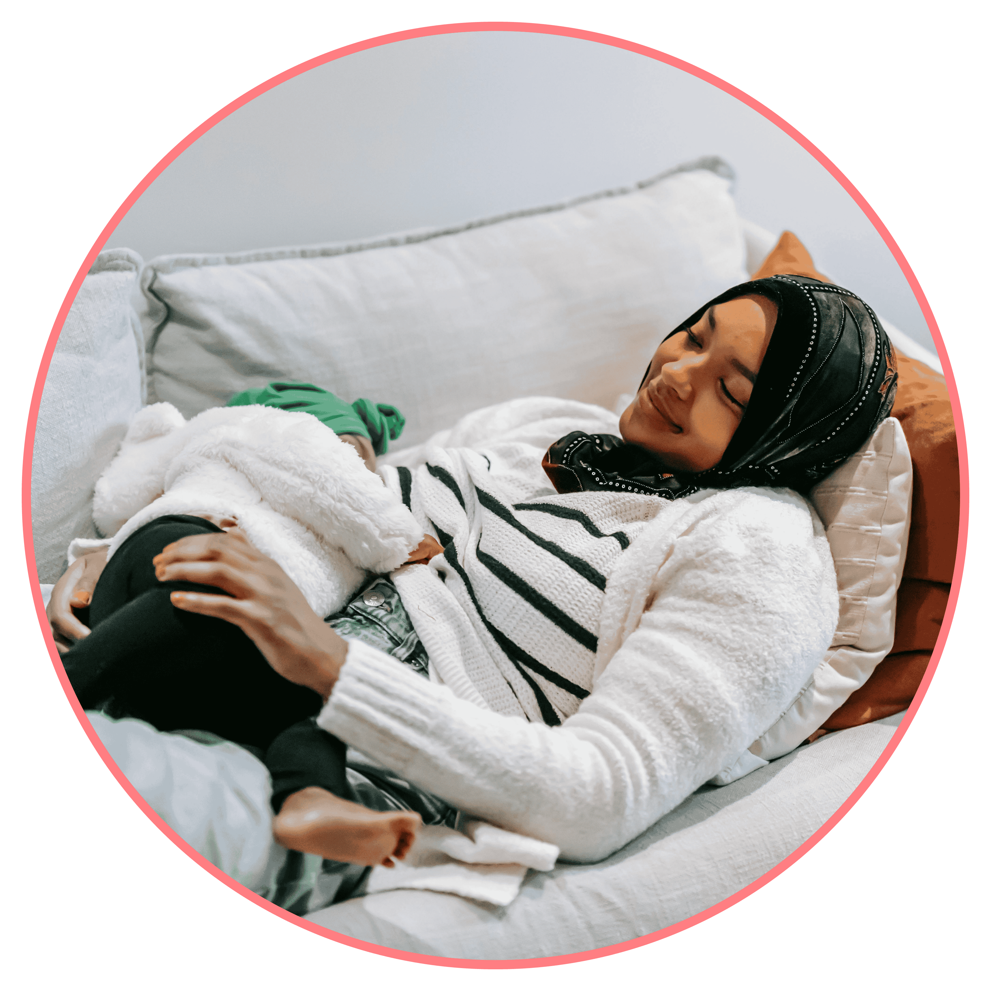 Picture of a woman resting on the sofa with her baby